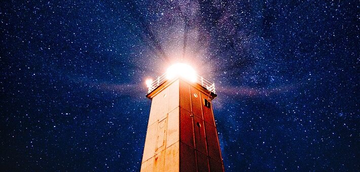 Lighthouse shining against deep blue sky