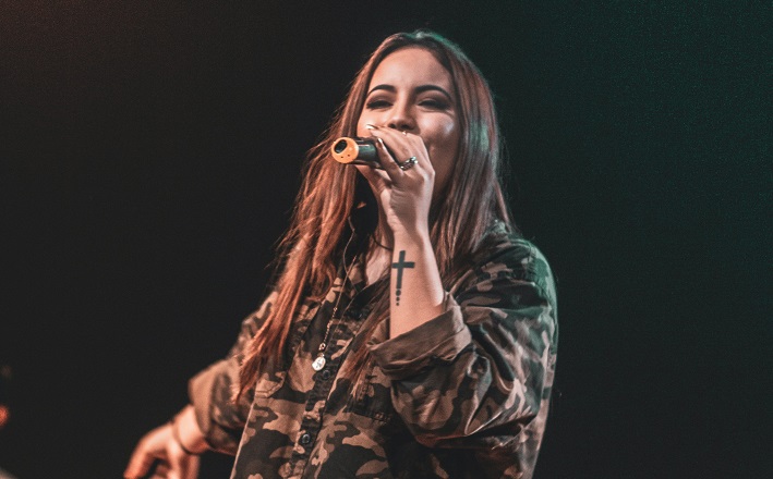 woman testifying in worship