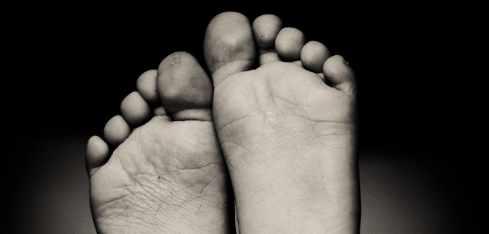 bare feet on black background