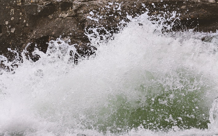 water crashing on shore