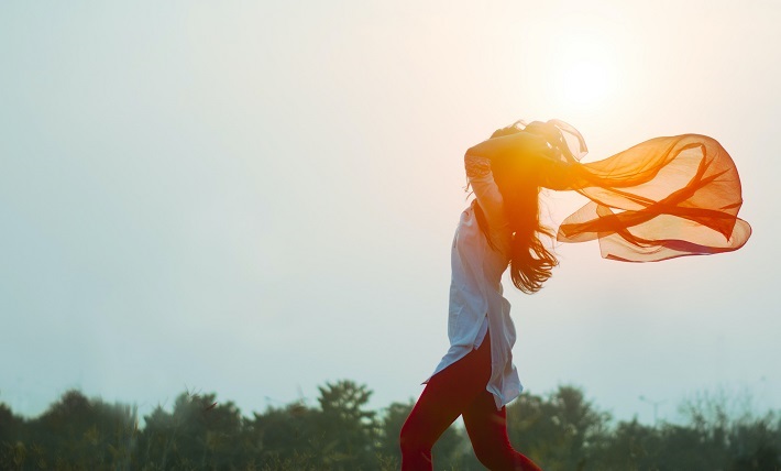 woman with scarf blowing in wind