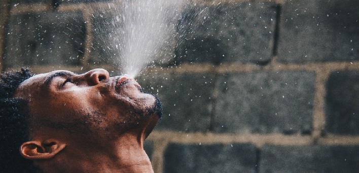 Man spraying water into the air