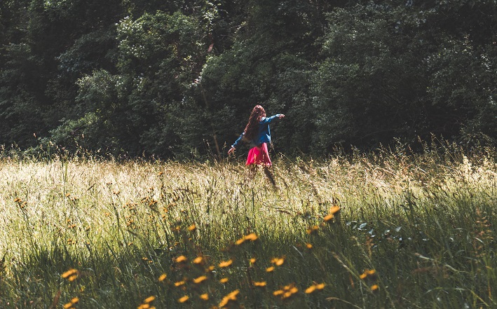 woman walking in sunny field