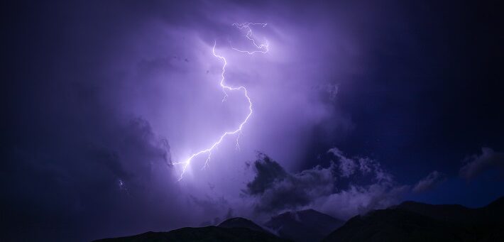 lightning strike on purple cloud background