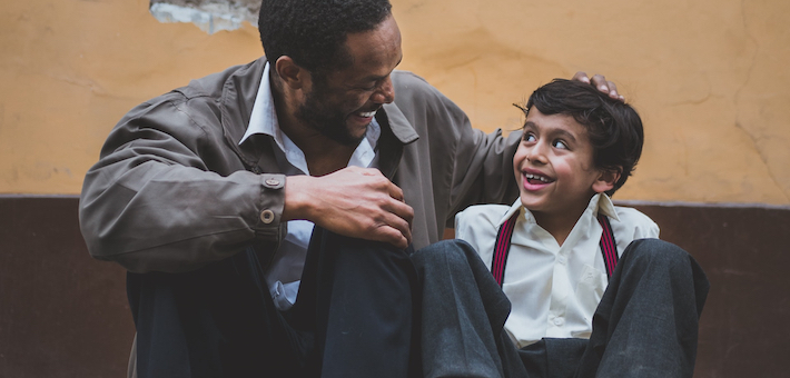 Man and boy smile at each other