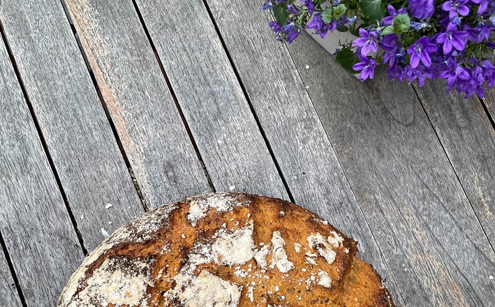 bread and flowers on wood table