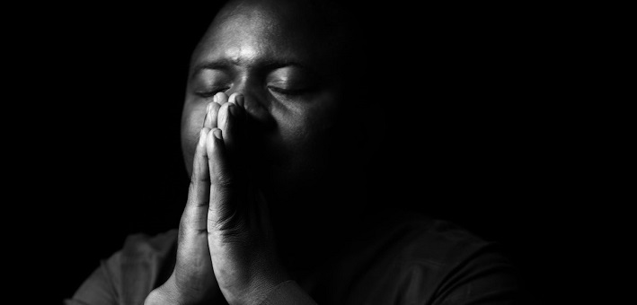 man praying fervently