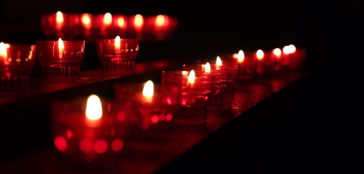 Votive candles in darkened space