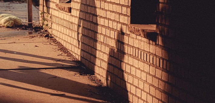 Shadow figures on a brick wall