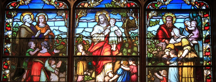 Stained-glass depiction of Jesus with children