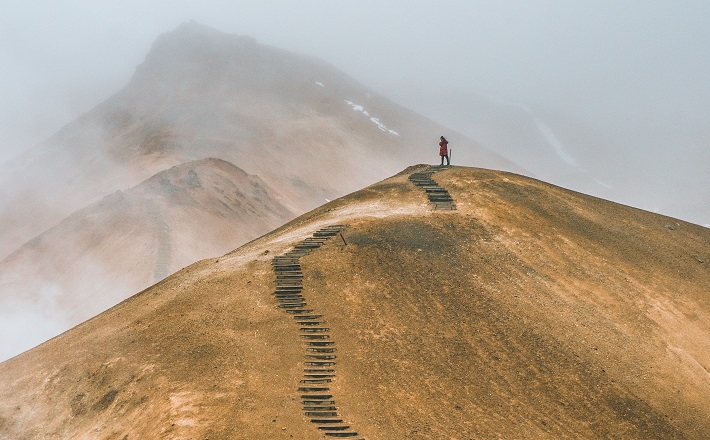 hiker on ridge with thousands of steps