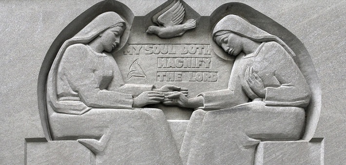 Stone carving of Mary and Elizabeth touching hands