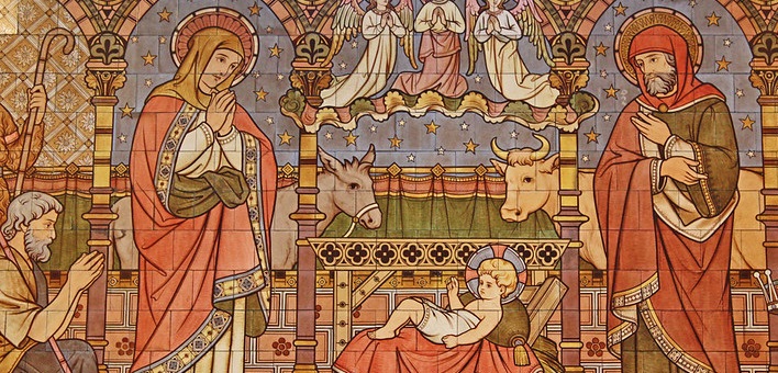 Shepherd kneels in front of baby Jesus