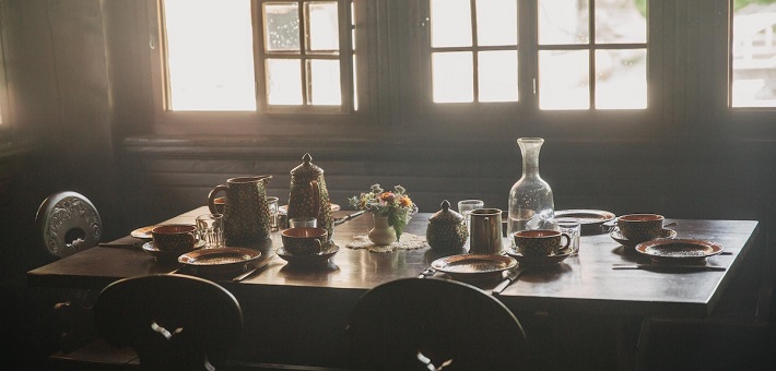 table set for feast with sunlight streaming in