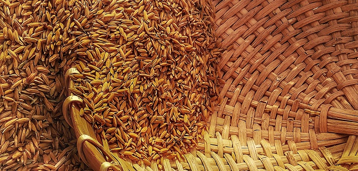 grain overflowing into a basket