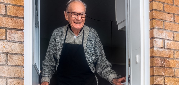 old man smiling in doorway