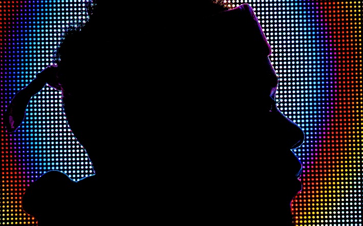 Silhouette of man in front of pixelated screen