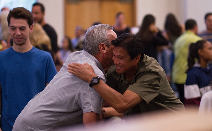 Two men hugging in worship service