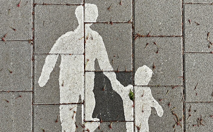 Sidewalk art - silhouette of parent walking with child