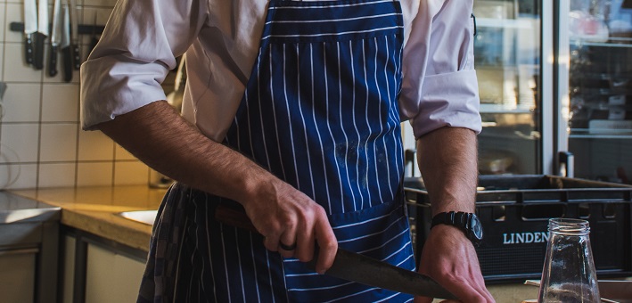 Chef with apron in kitchen