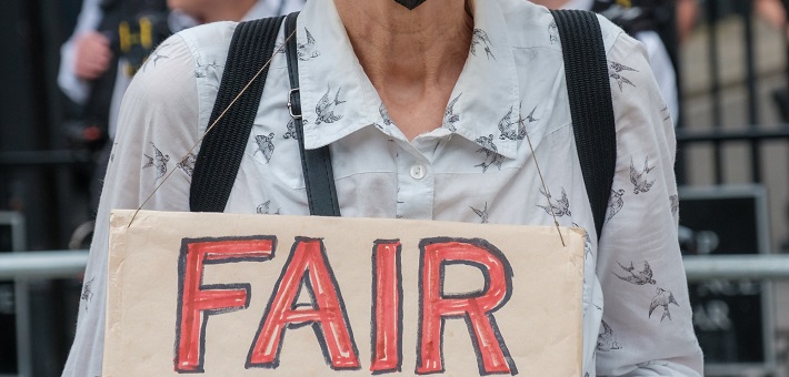 woman holding sign saying 