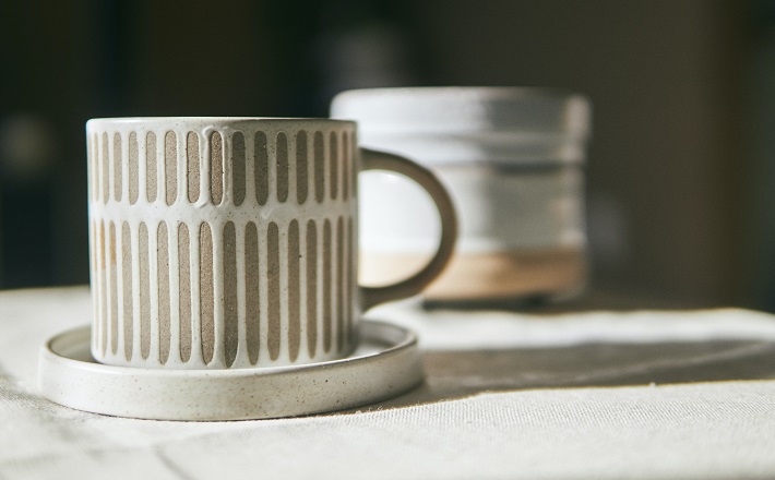 Earthenware mugs on white table