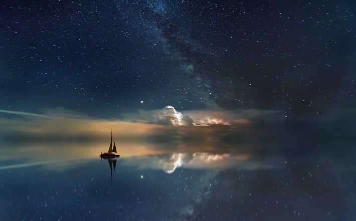 boat sailing on calm sea in twilight