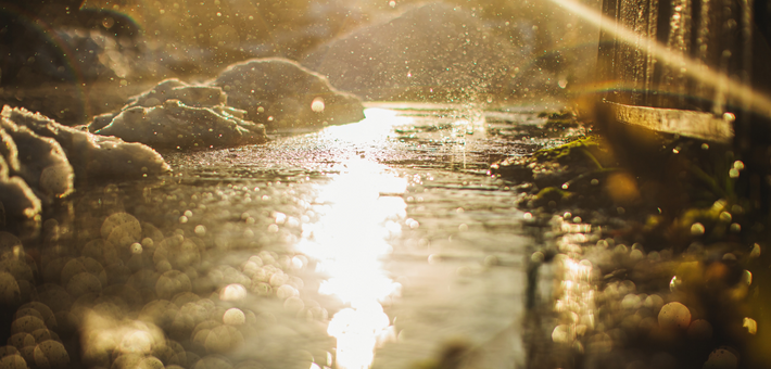 puddle of wet snow and salts reflecting bright light