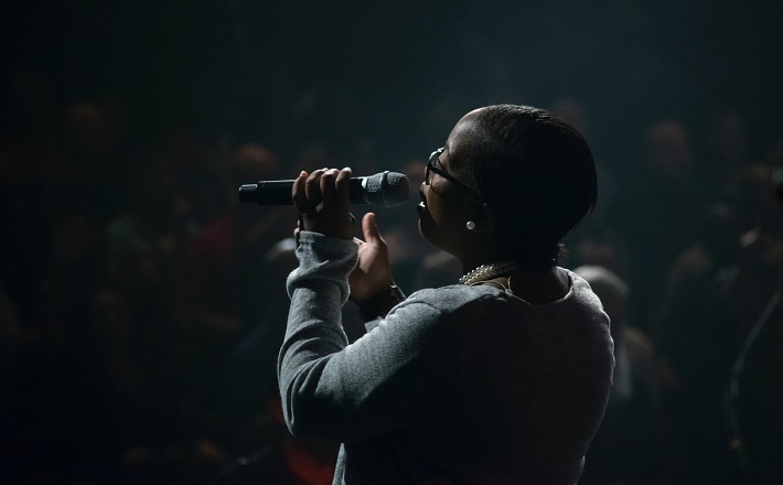 Woman singing to a crowd