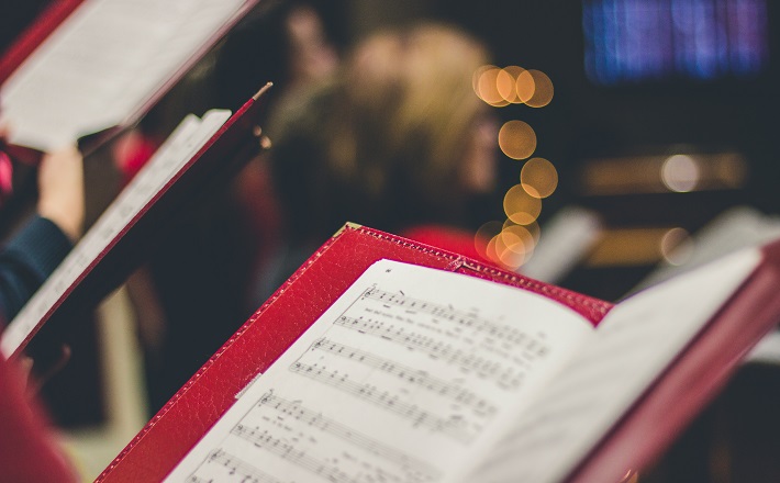 Worship service with singers holding music