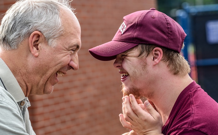 Two men smiling at each other