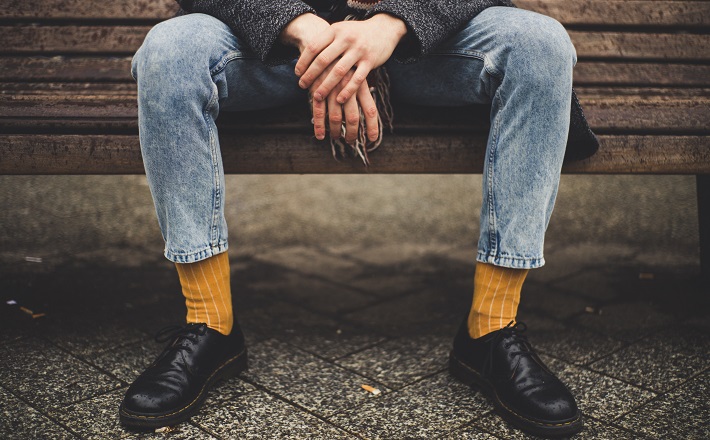 person sitting alone on bench