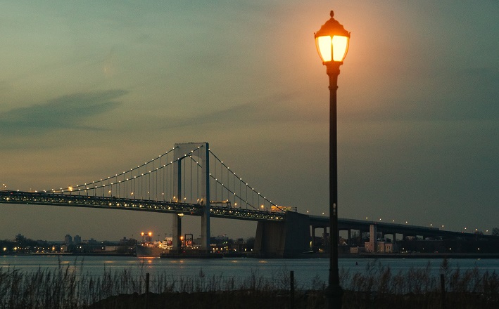 Summer night streetlight in front of bridge