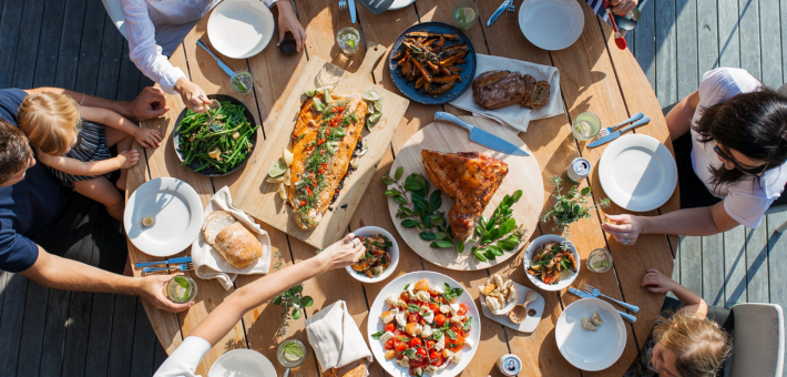 People around a table, photo by Luisa Brimble.