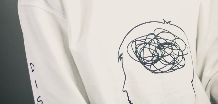 white sweatshirt with cartoon of figure with scribbles for brains