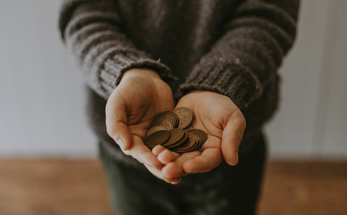 child holding coins in hand (Crafting a sermon on Luke 21:1-4)