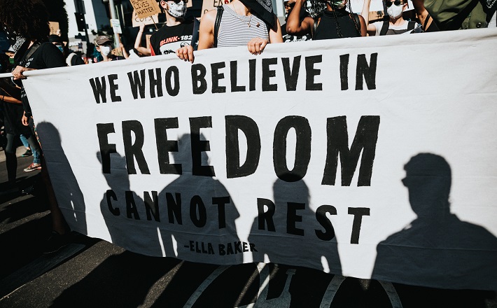 We who believe in freedom cannot rest - sign at protest