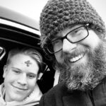 Pastor smiling with young driver who received ashes on forehead