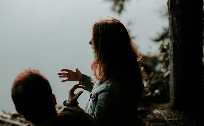 Woman speaking by a lake