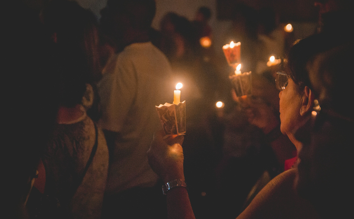 Photo of people holding candles at an Easter Vigil service