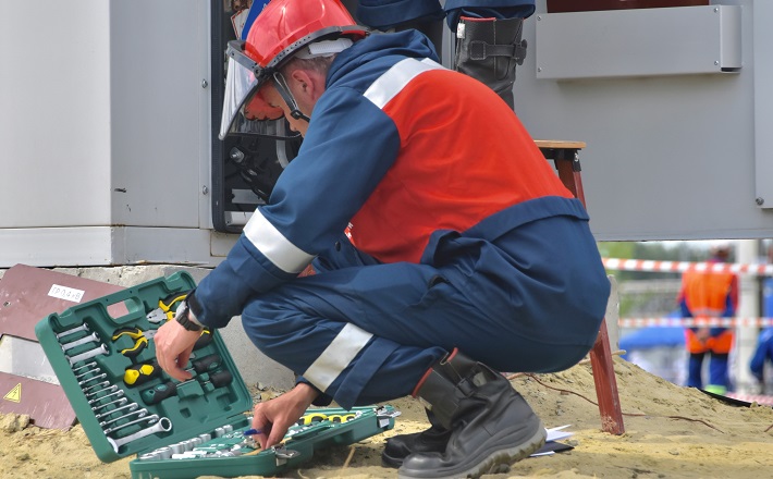 Maintenance worker gathering tools on job site