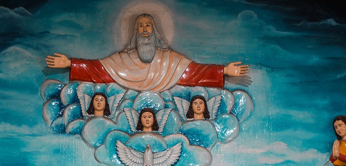 Sculpture with bearded figure surrounded by three angels