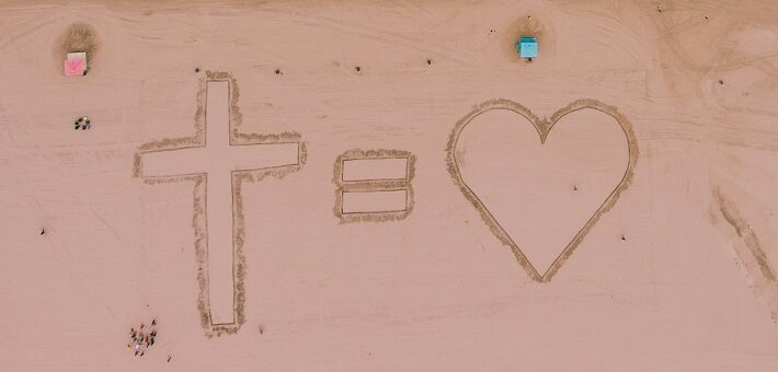 Sand art with cross = heart (God is love)