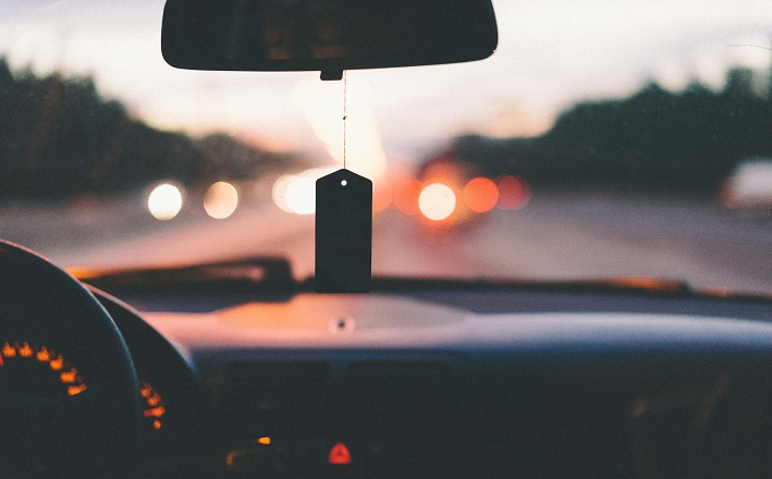 View inside car at dusk with air freshener dangling