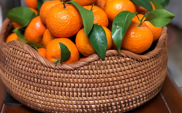 Basket overflowing with small oranges