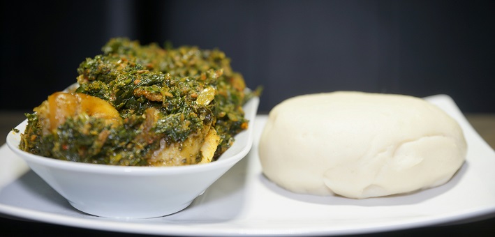 Fufu and eforiro on white plates (Bread of Life series)