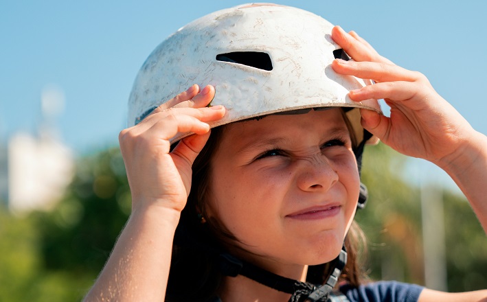 Young person wearing a skateboard helmet