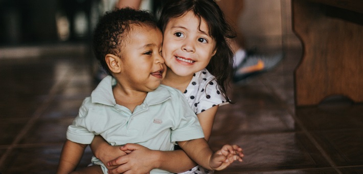 Children embracing with smiles