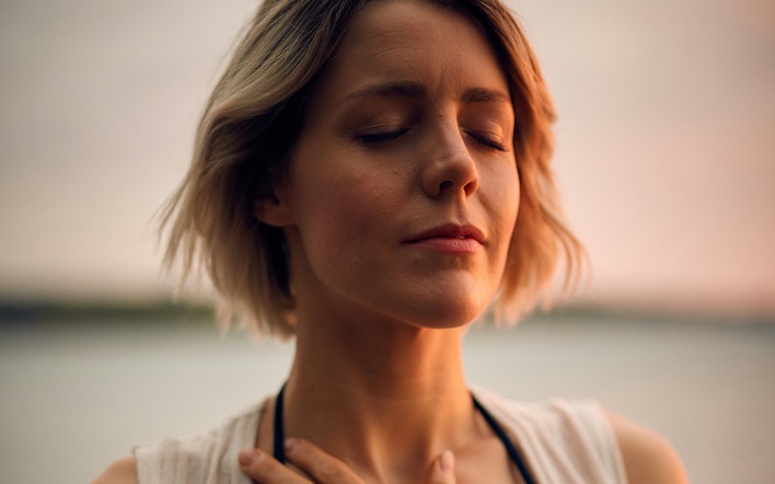 Woman with hand on her heart