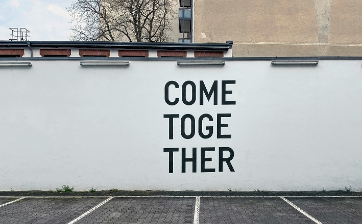Plain black text painted on white wall: 